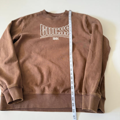 Brown sweatshirt with 'Guess' logo and a measuring tape on a white background