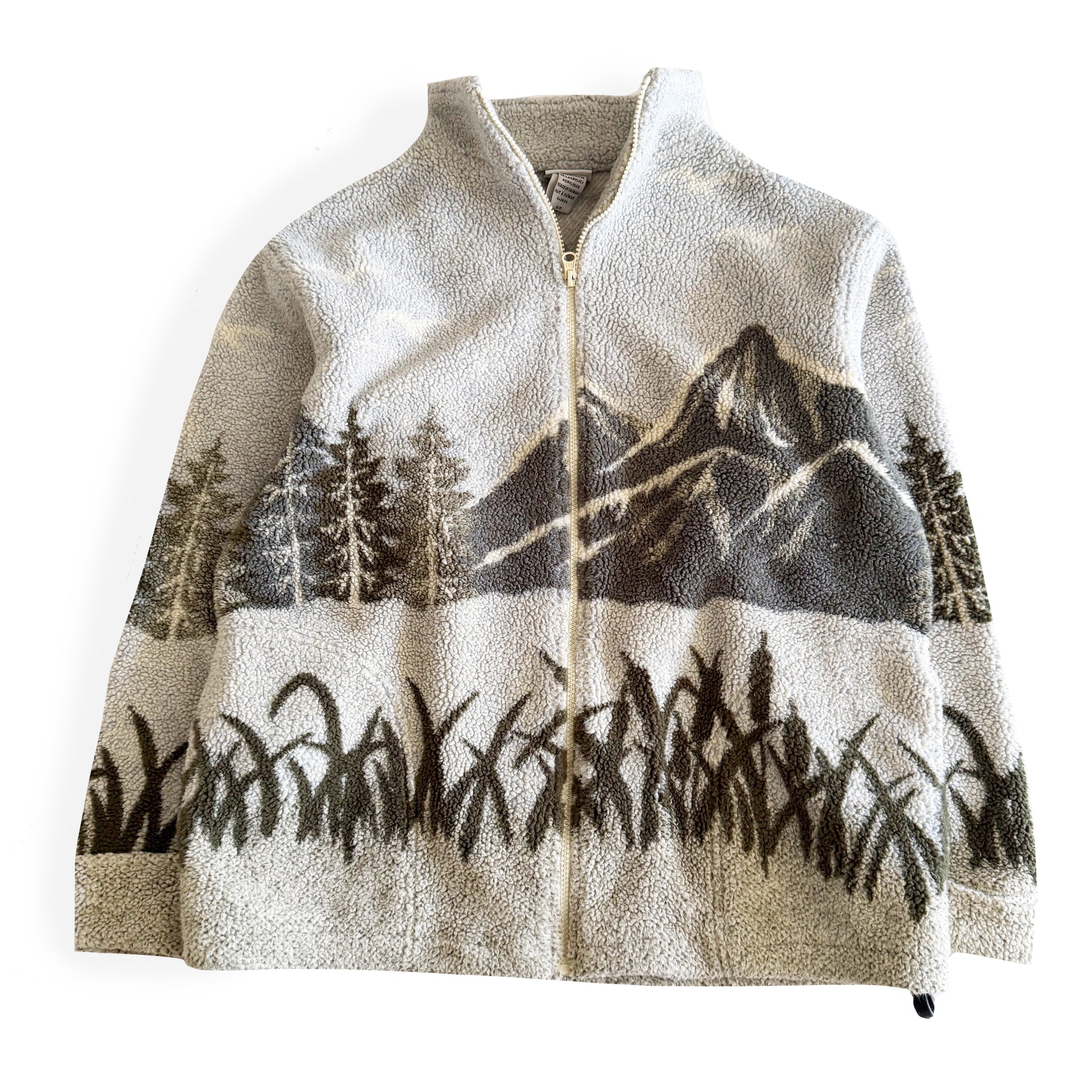 Fleece textured sweater with a mountain marsh forest scene on it, and a zippered close - on a white backdrop. 