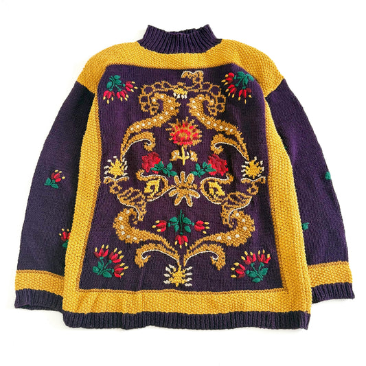 A vintage knitted sweater with a floral textured design in purple and yellow colors